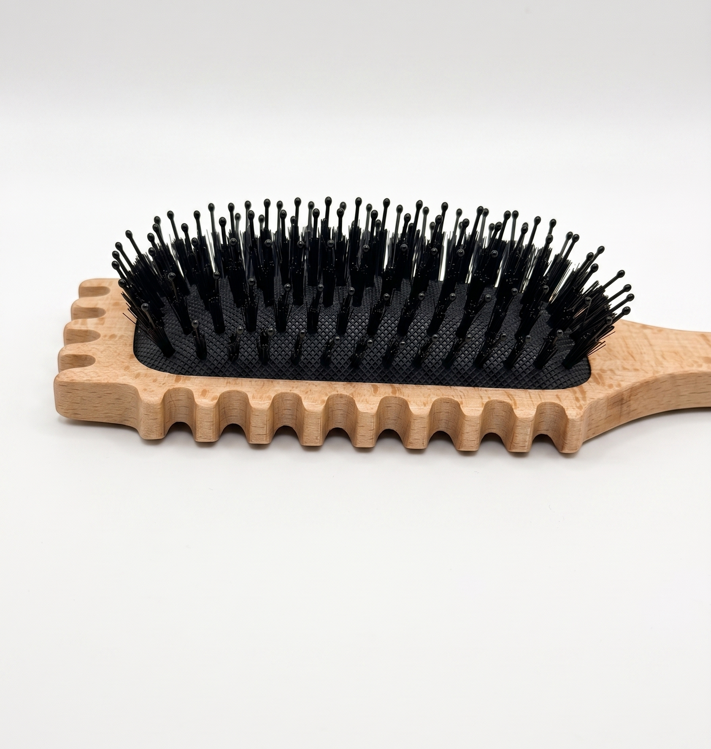 Portable and travel-friendly curly hairbrush tucked into a modern handbag.
